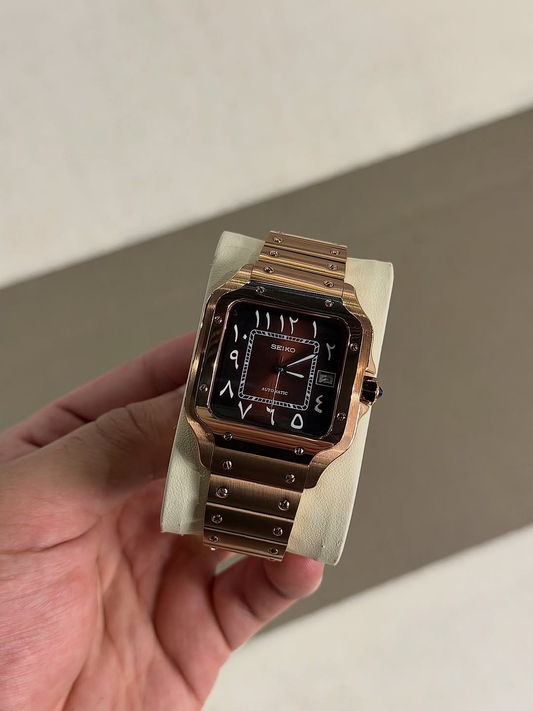 Rose Gold Arabic Seiko mod watch on wrist with luxury design