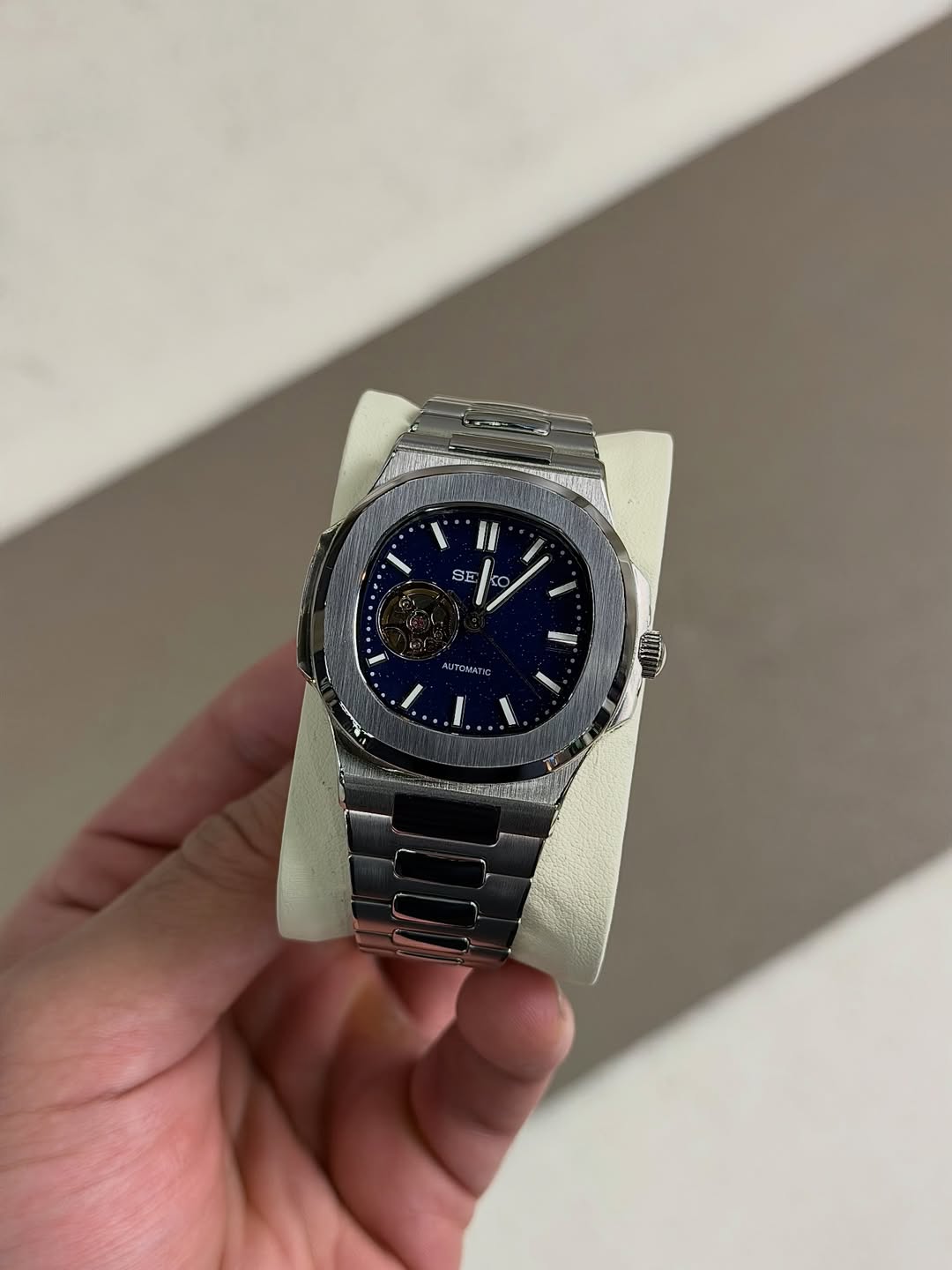 Blue Open Heart Seiko mod watch on wrist with luxury design