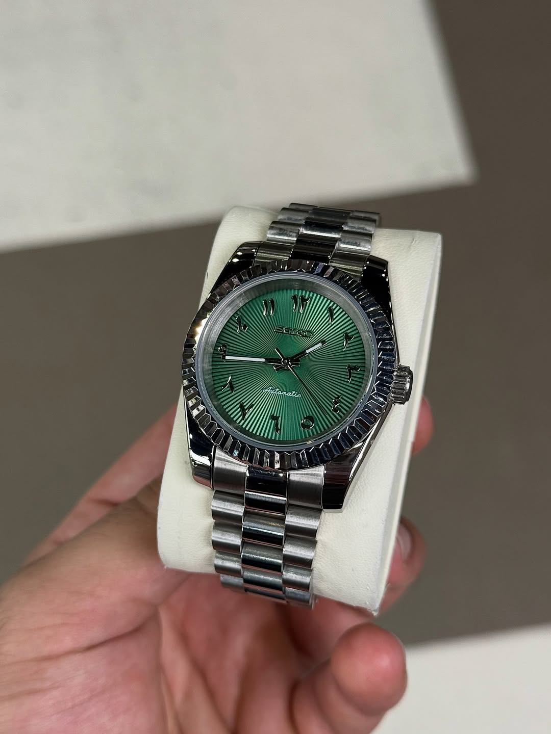 Forest Green Arabic Dial Seiko mod watch on wrist with luxury design