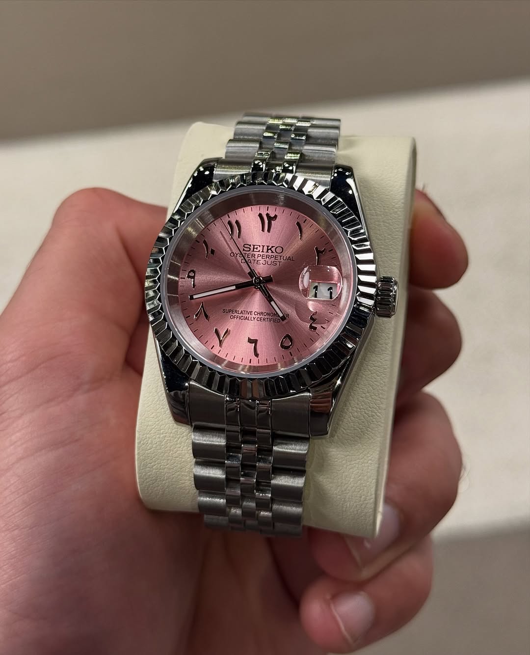 Pink Arabic Dial Seiko mod watch on wrist with luxury design